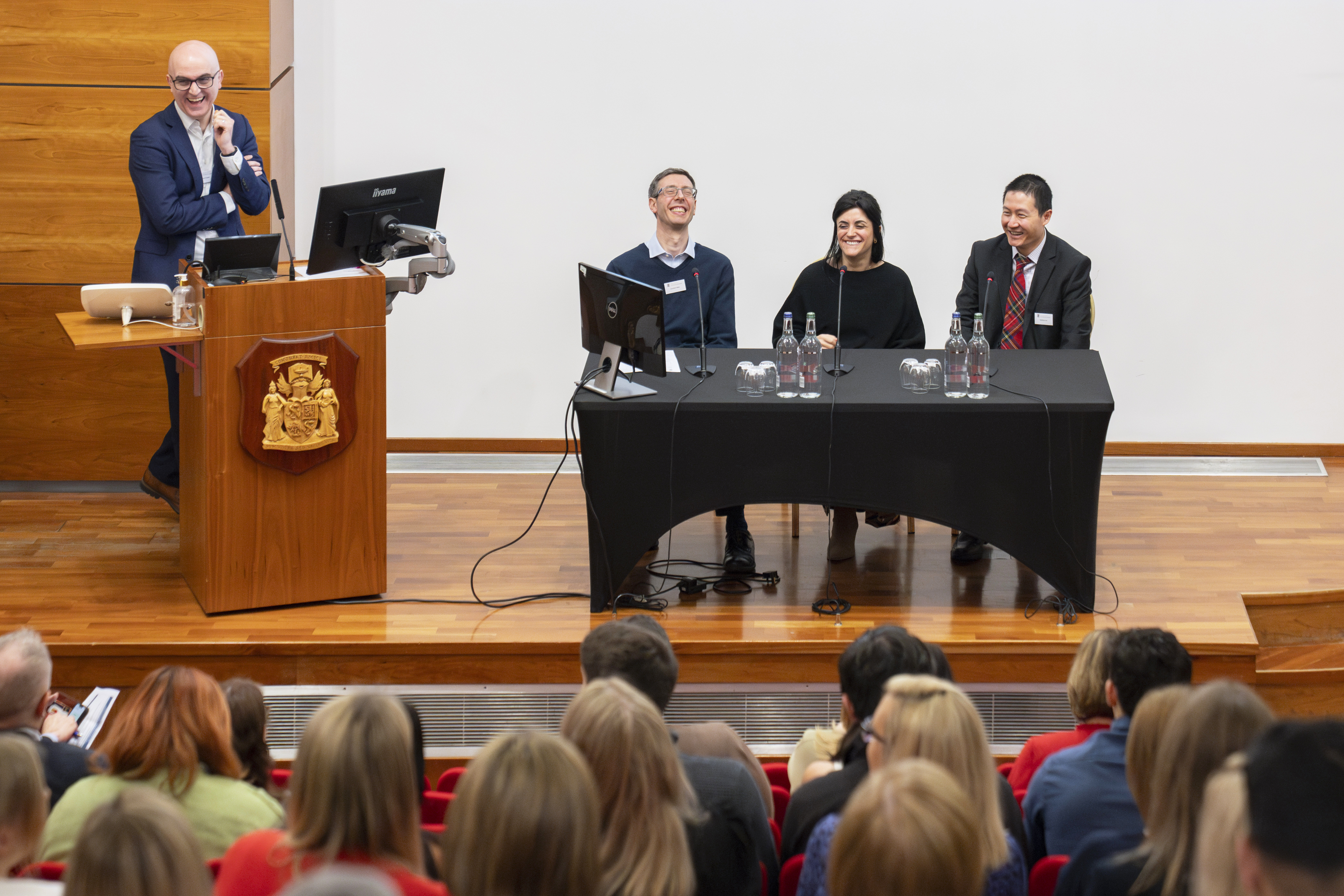 a panel smiling at the conference
